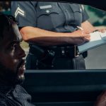 A police officer issuing a ticket to a driver during a traffic stop.