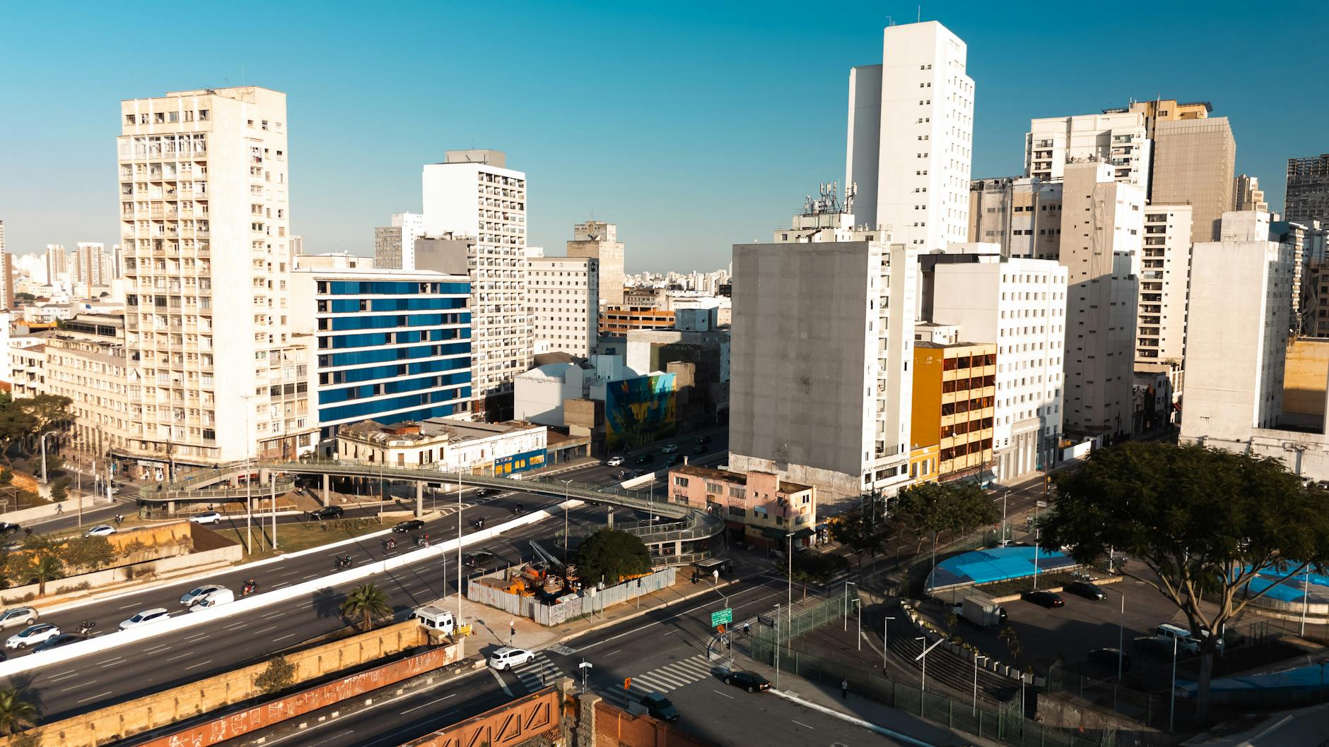 Aerial view of São Paulo's modern buildings and urban layout under a clear blue sky.