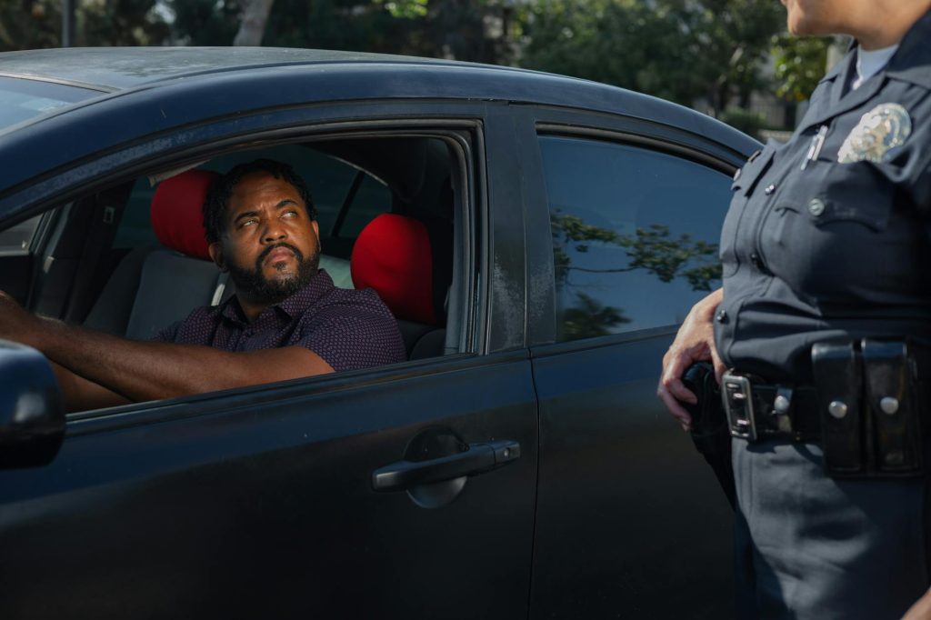 A driver receives a traffic ticket from a police officer for a speeding violation.
