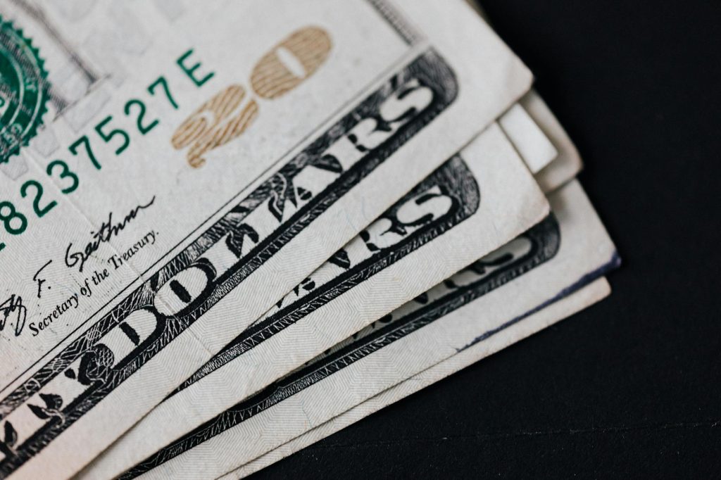 Closeup of USA 20 dollar banknotes placed on black background as national currency for business and personal financial operations