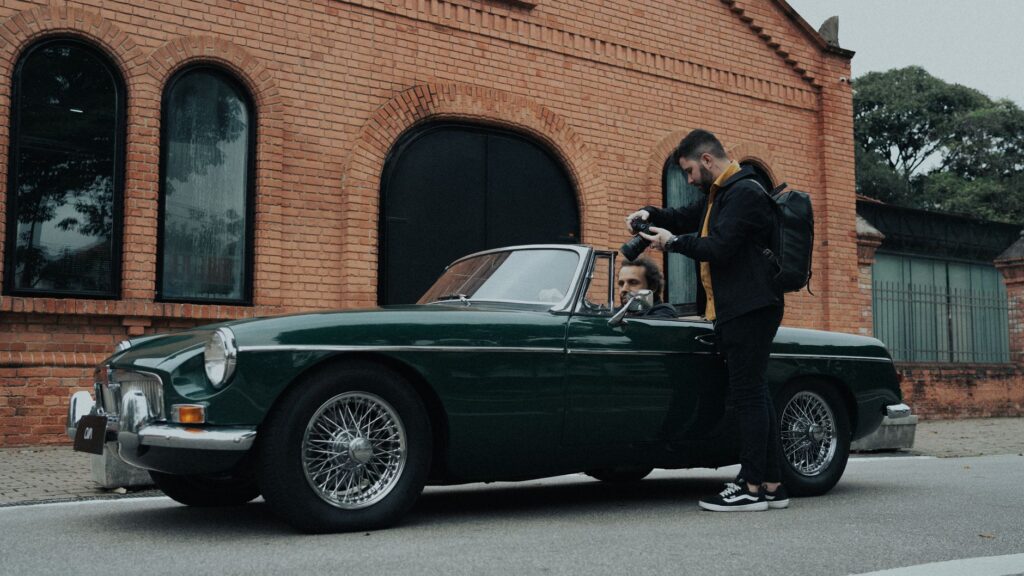 A photographer takes a picture of a vintage car with a driver in São Paulo, Brazil.