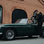 A photographer takes a picture of a vintage car with a driver in São Paulo, Brazil.