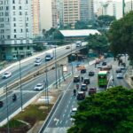 An overhead view showcasing the bustling traffic on a São Paulo highway amid green urban surroundings.