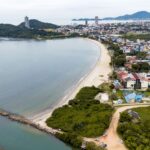 Aerial view of São Francisco do Sul, Brazil, showcasing the coastline and urban landscape.