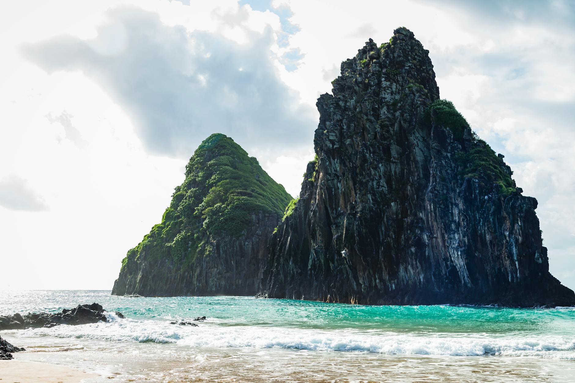Stunning rock formations rise from the clear waters of Cacimba do Padre beach, Brazil, capturing nature's beauty.