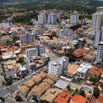 Aerial view of a residential district in MG, Brazil, showcasing diverse architecture and urban layout.