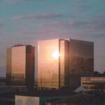 Sunset light reflects on modern glass skyscrapers in Rio de Janeiro, creating a stunning visual effect.