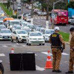 Police officers manage traffic congestion in a busy urban city street.