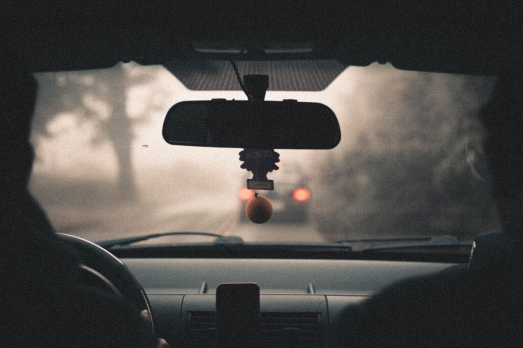 Foggy view from inside a car driving through a misty road in Campos do Jordão, Brazil.
