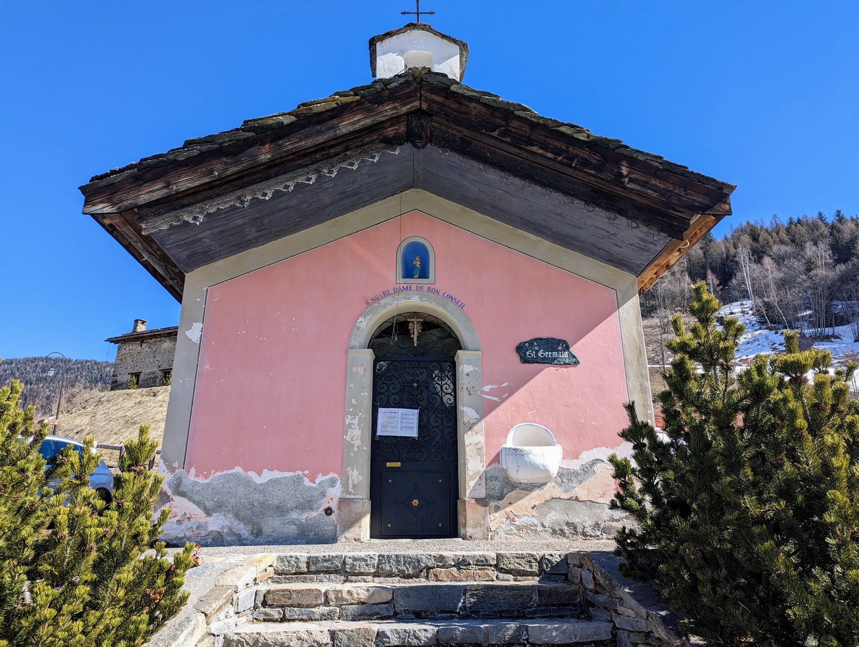Charming small chapel in Sainte-Foy-Tarentaise, Auvergne-Rhône-Alpes, France, under a clear blue sky.