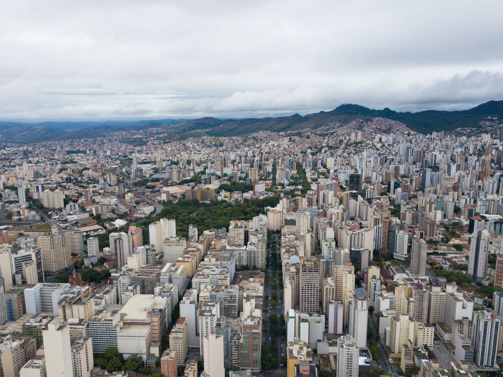 Breathtaking aerial view of Belo Horizonte, Brazil cityscape with high rises and distant mountains.