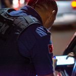 A GCM officer checks documents during night traffic control in Londrina, Brazil.