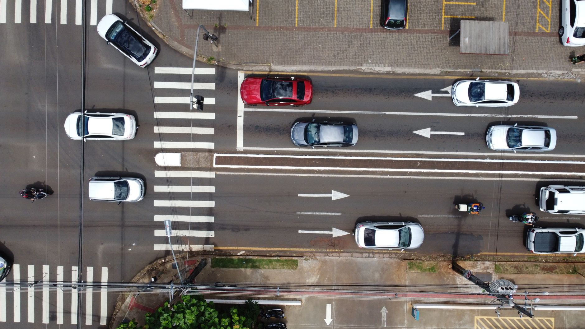Aerial drone view of vehicles and traffic on a busy street in Londrina, Brazil.