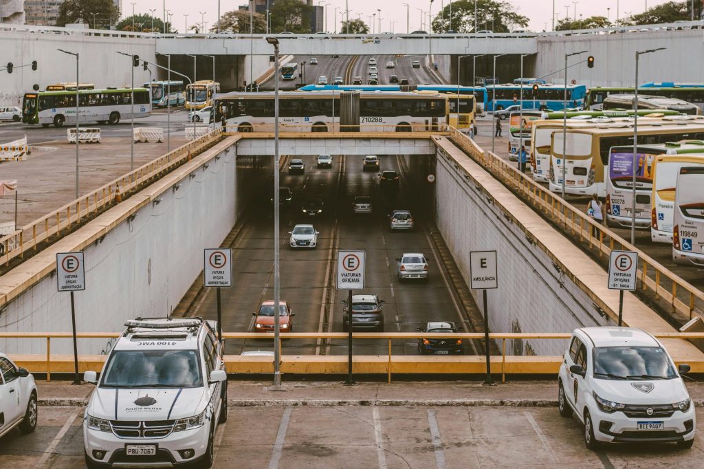 Busy urban overpass showing buses and cars commuting through a city intersection.