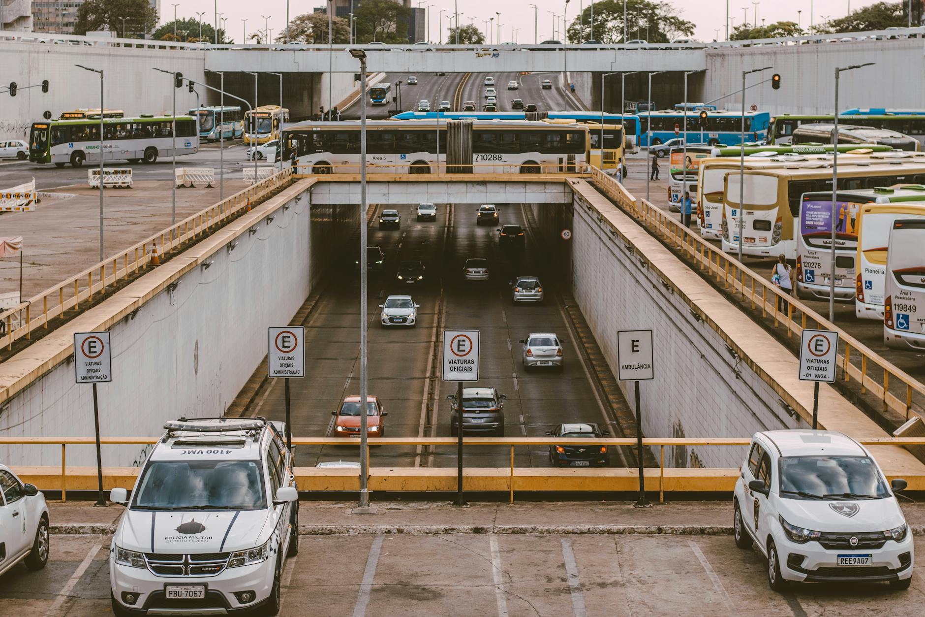 Busy urban overpass showing buses and cars commuting through a city intersection.