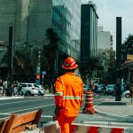 Urban scene in São Paulo with construction worker and bustling street life.