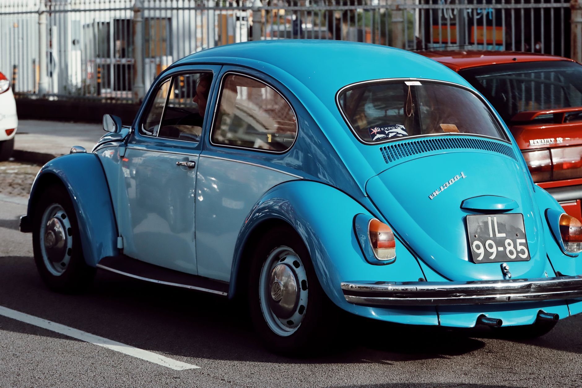 Classic blue Volkswagen Beetle parked on a street in Porto, Portugal.