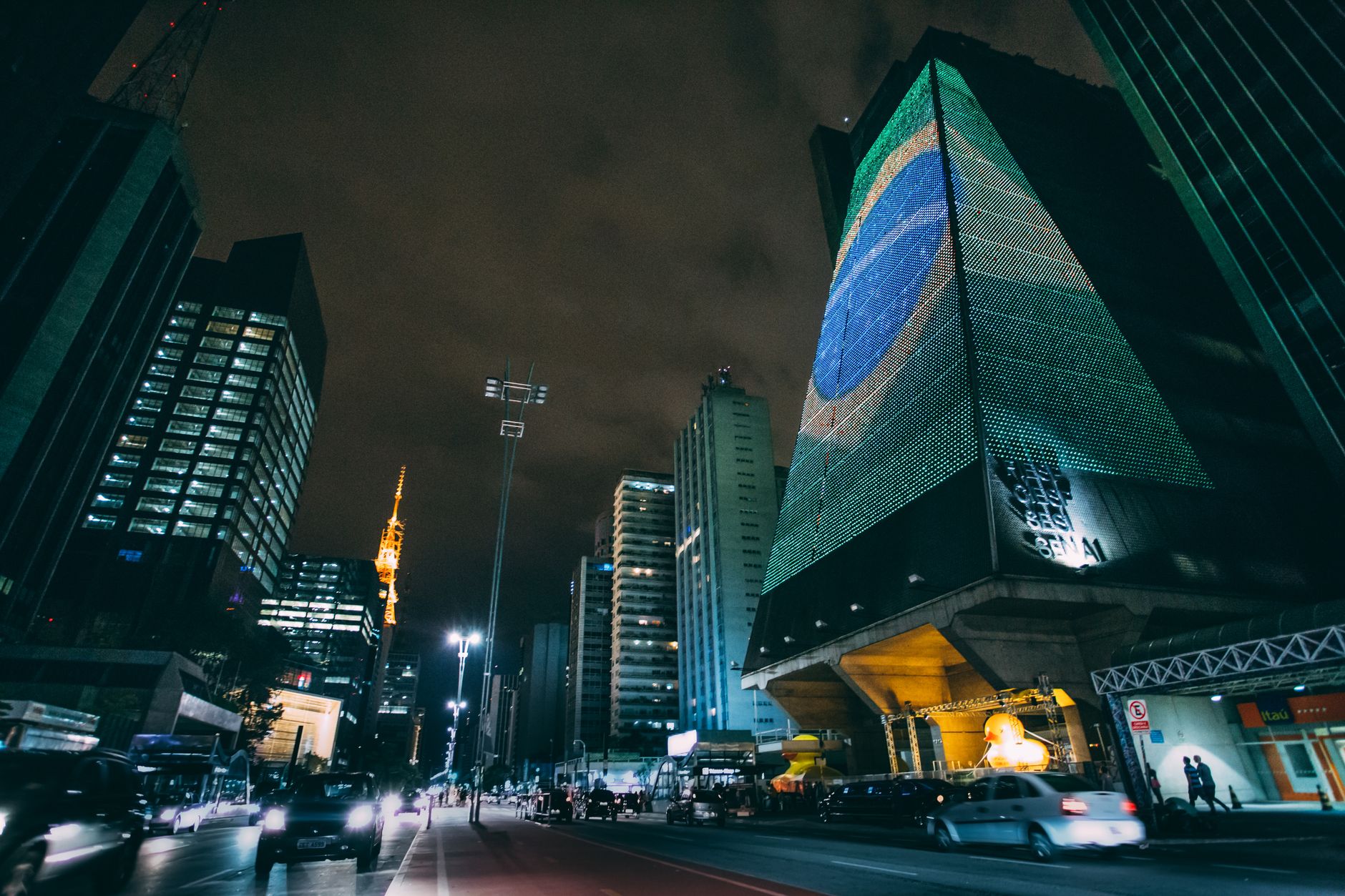 A dynamic nighttime cityscape in Sao Paulo featuring modern skyscrapers and street lights.