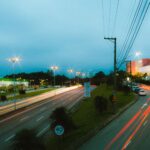 Dynamic long exposure shot of city highway at night with light trails.