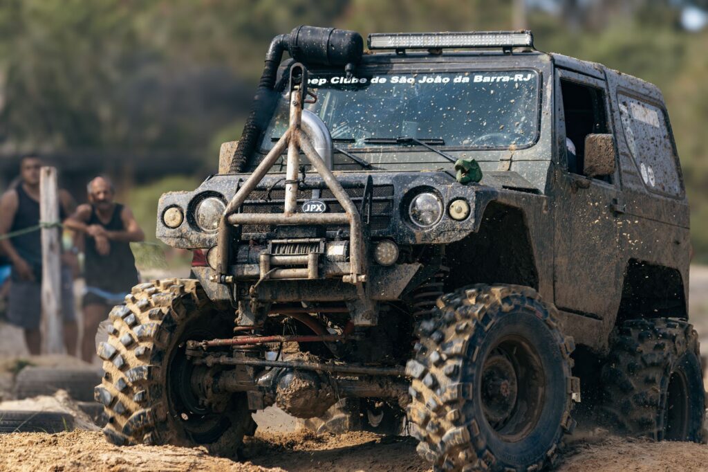 A rugged off-road jeep conquering muddy terrain during a thrilling rally event.