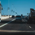 Busy urban expressway filled with vehicles in motion under a clear blue sky, showcasing modern transportation.