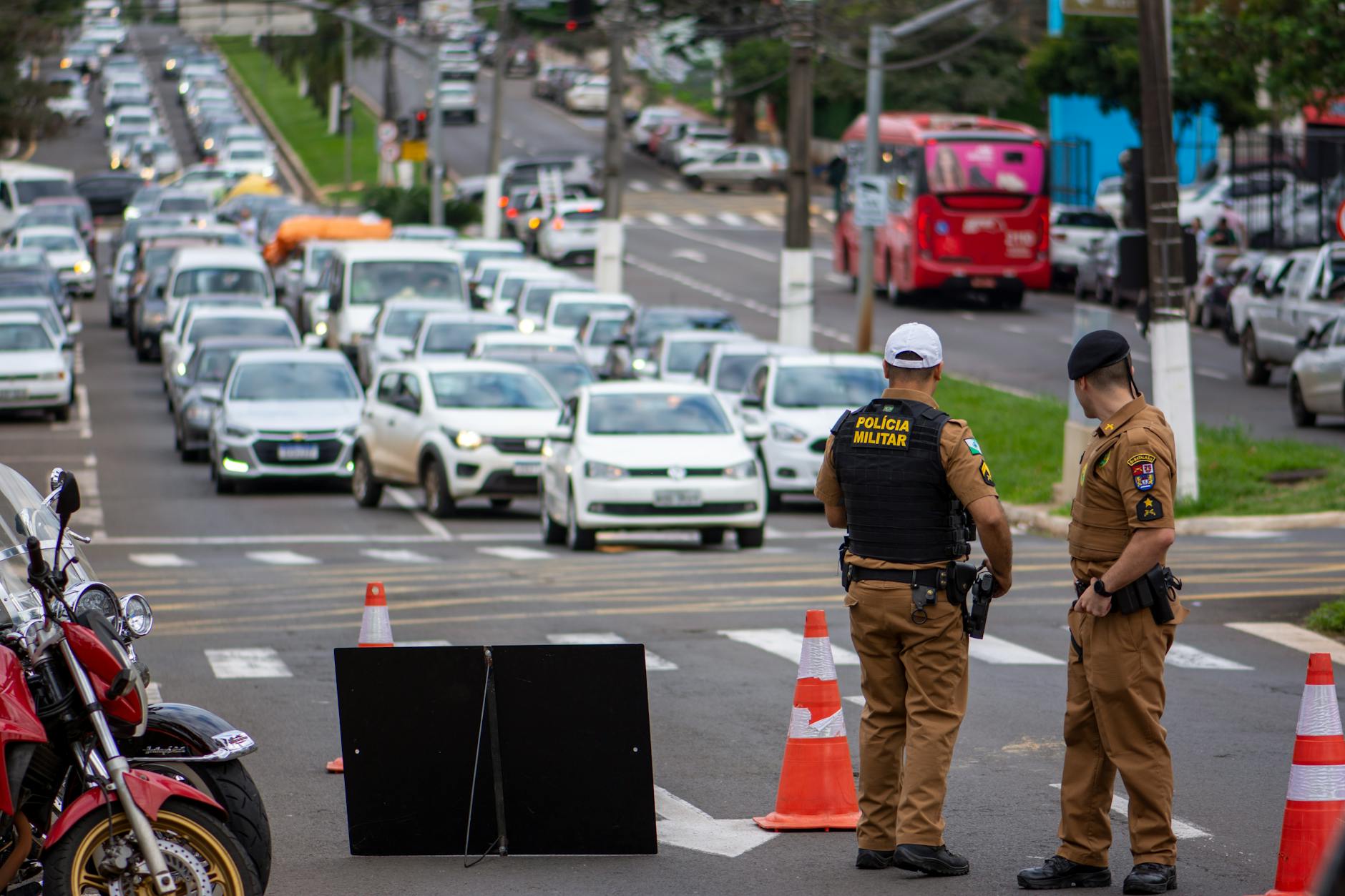 Police officers manage traffic congestion in a busy urban city street.