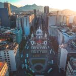 Drone shot capturing the stunning skyline and architecture of Rio de Janeiro with prominent cathedral.