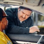 A police officer interacts with a driver through a car window, emphasizing law enforcement and public safety.