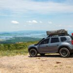 Explore Serra da Canastra with an SUV equipped for adventure on a scenic overlook.