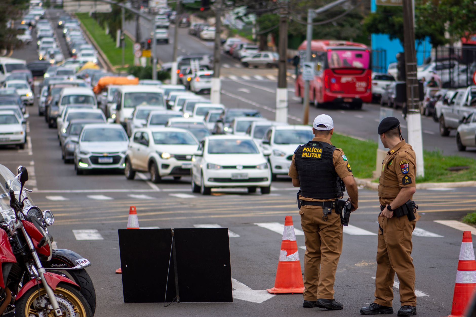 Police officers manage traffic congestion in a busy urban city street.