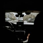A cityscape view from inside a vehicle showcasing urban traffic and buildings.