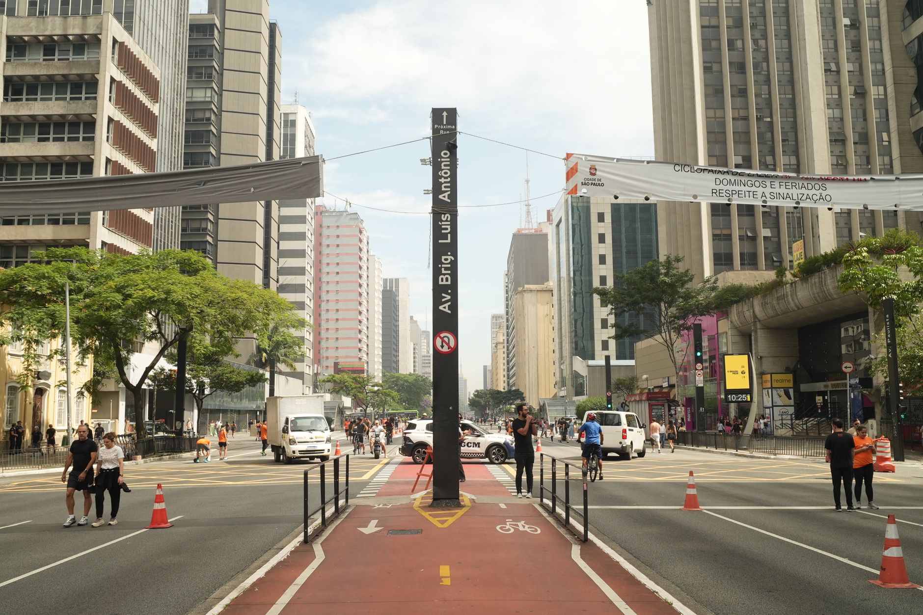 Street view of Avenida Paulista in São Paulo filled with people and traffic.